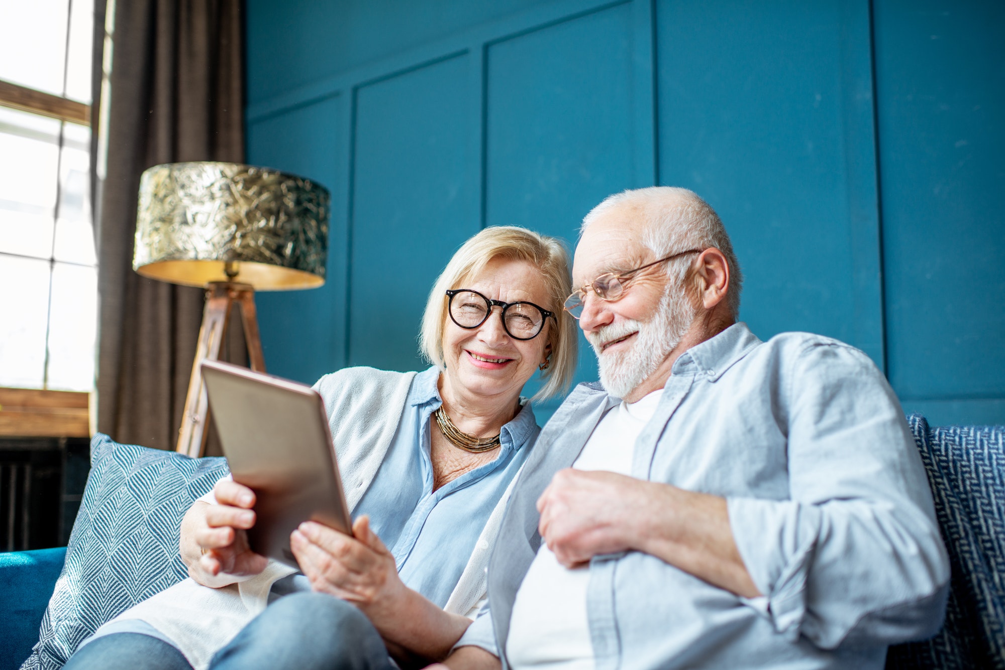 Senior couple with tablet at home